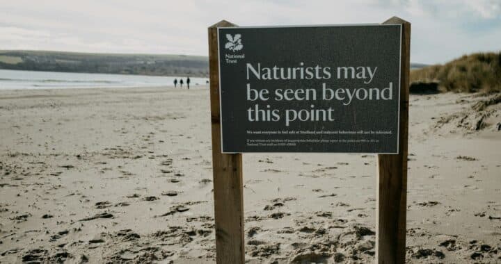 a sign on a beach that says naturalists may be seen beyond this point